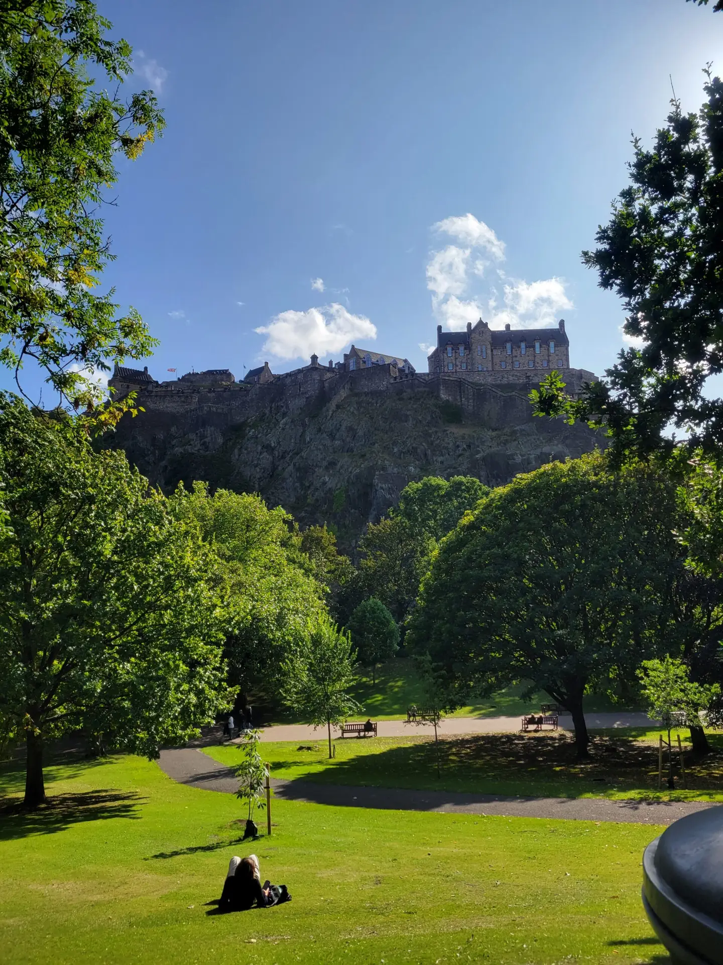 Woman lying in the park under Edinburgh Castle.