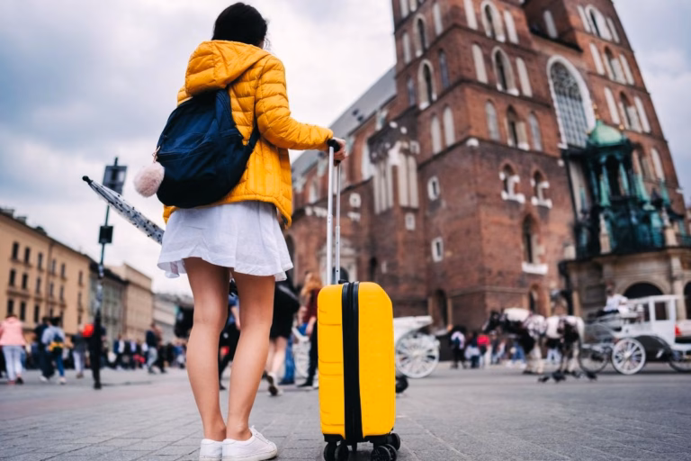 Woman with carry-on only bags arriving at a historic building during travels.