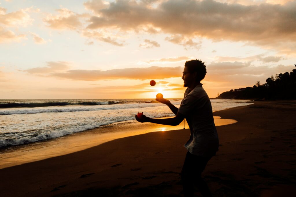 Man juggling on the beach