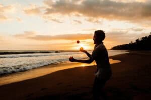 Man juggling on the beach