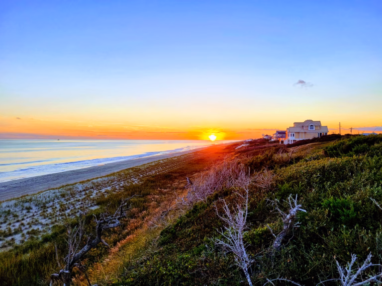 Indian beach view of the sun, a vacation home and the ocean.