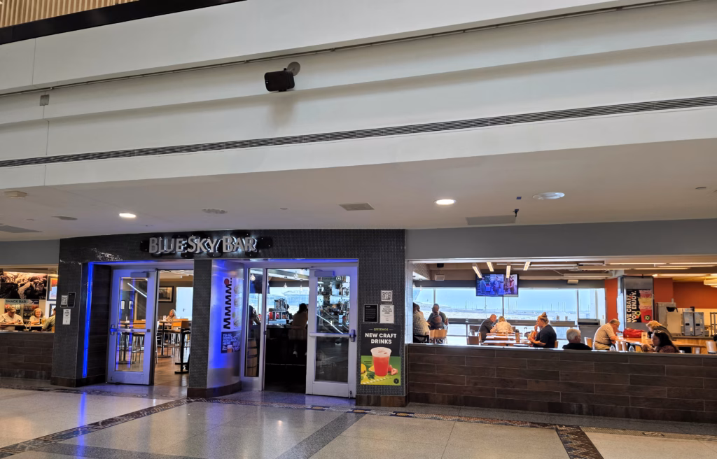 Blue Sky Bar located at bottom of escalators to Cap One Lounge in DEN