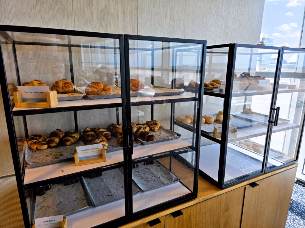 Pastry selection including croissants and lemon beignets at the Denver Capital One Lounge.