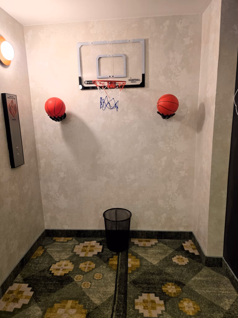 Go For Gold themed fifth-floor lobby with basketball décor and elevator area at the Curtis Denver hotel.