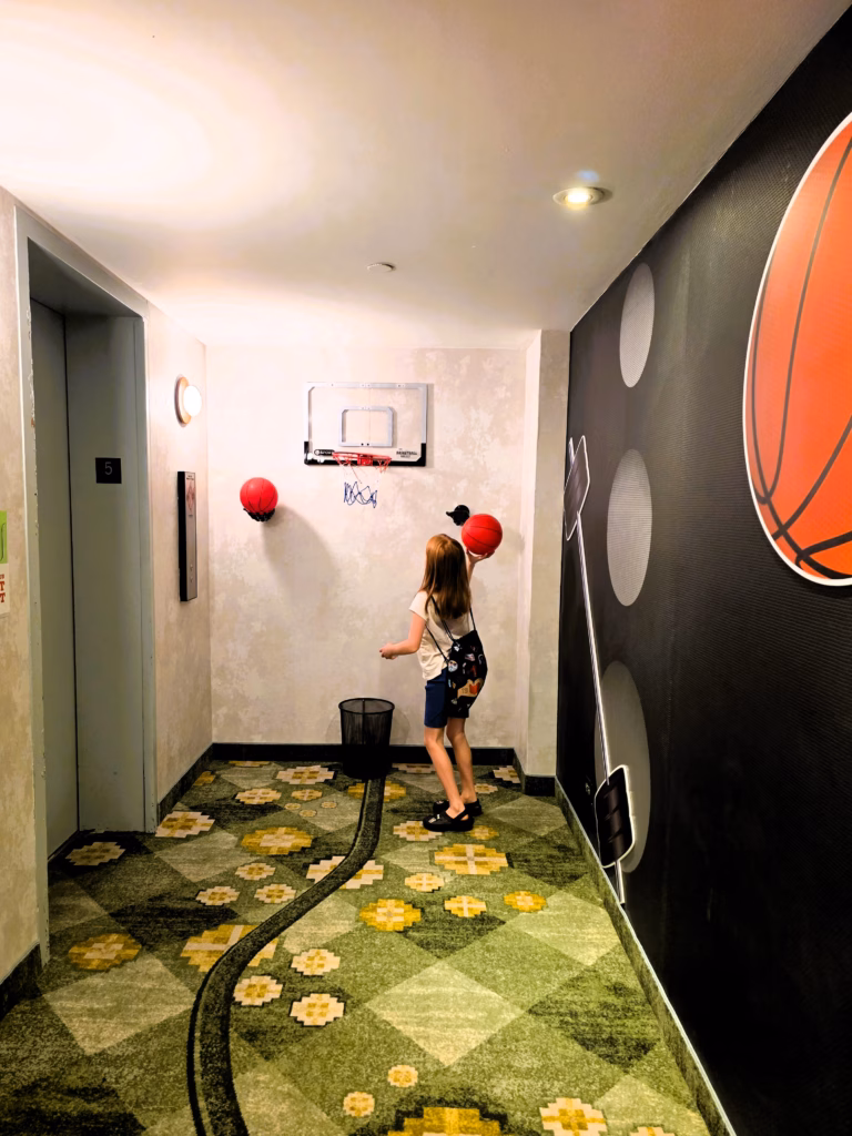 Interactive basketball wall on the fifth floor’s Go For Gold theme at The Curtis Denver.