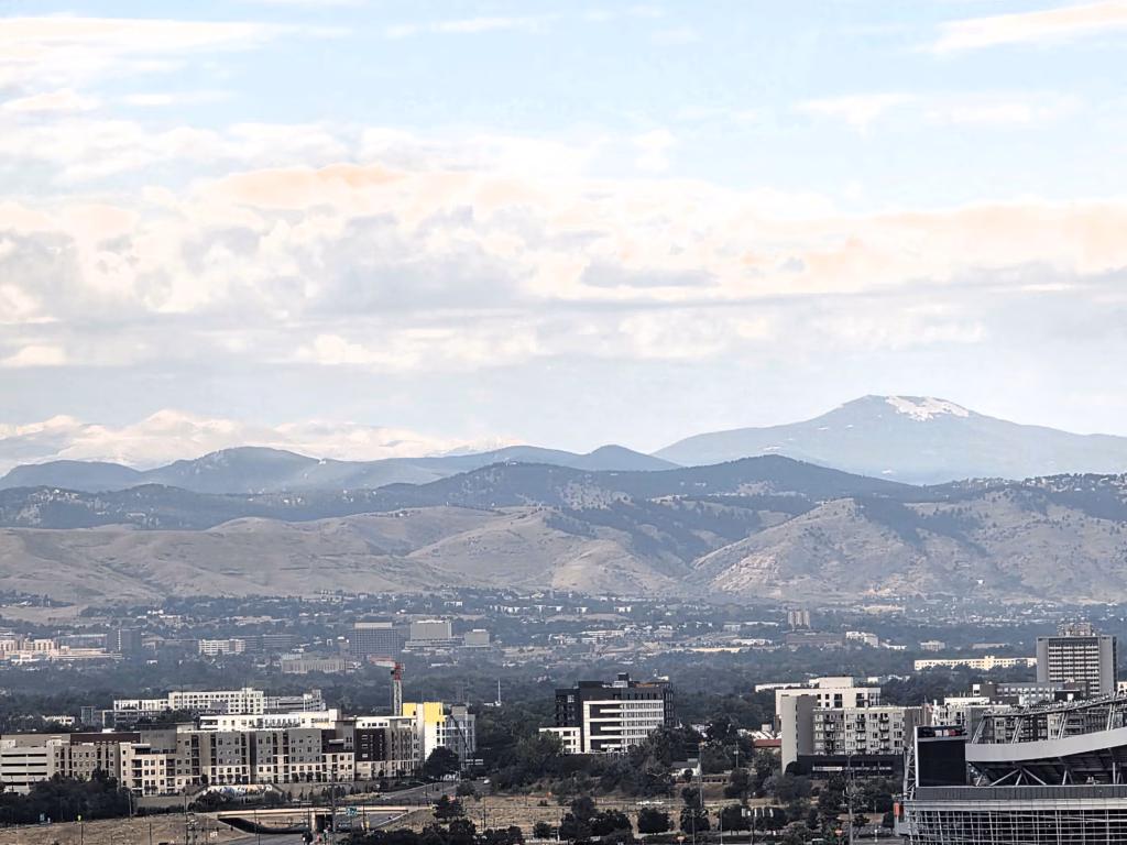 Zoomed-in view of the Rocky Mountains from a guest room at The Curtis Hotel.