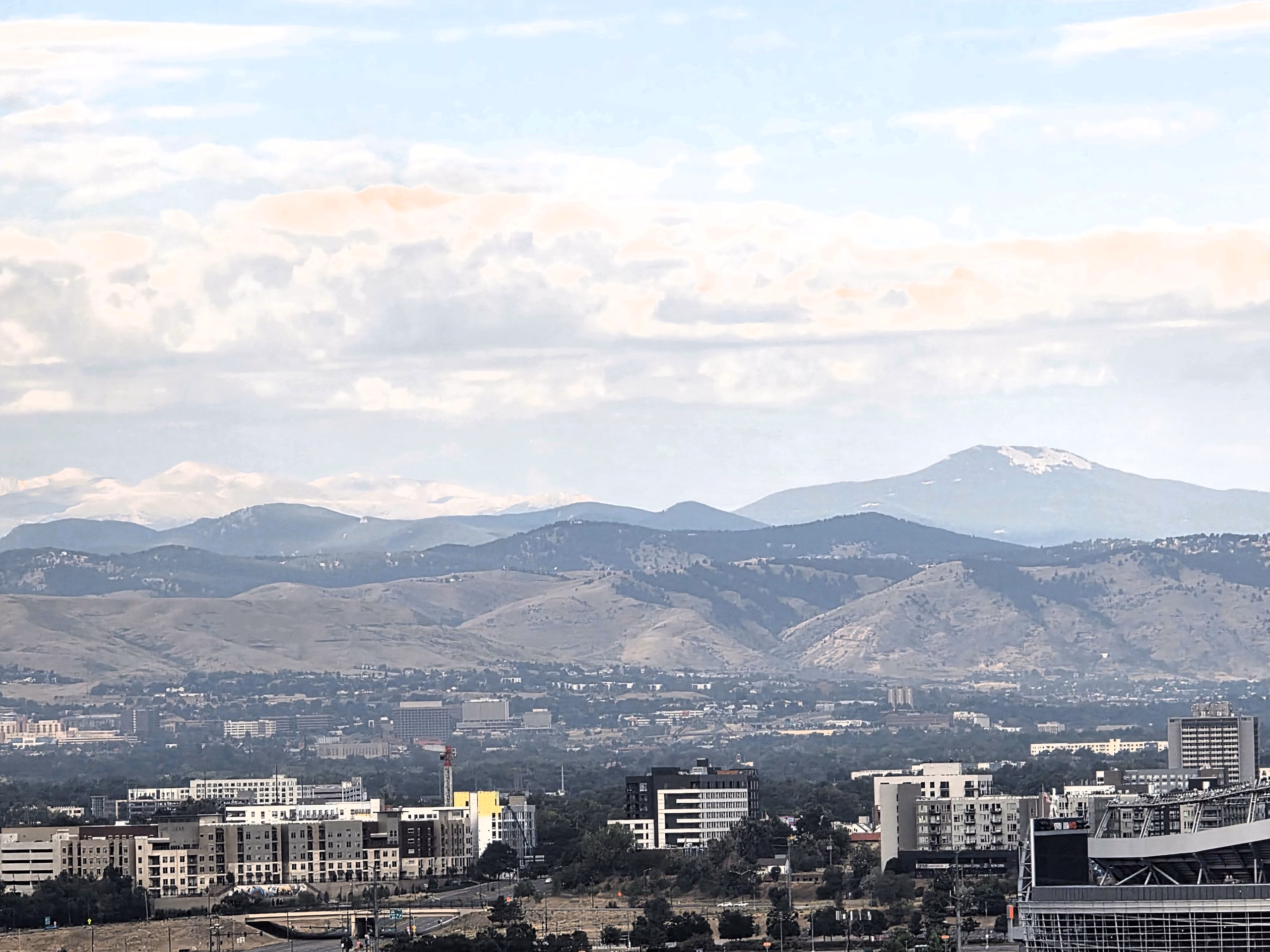 Zoomed-in view of the Rocky Mountains from a guest room at The Curtis Hotel.
