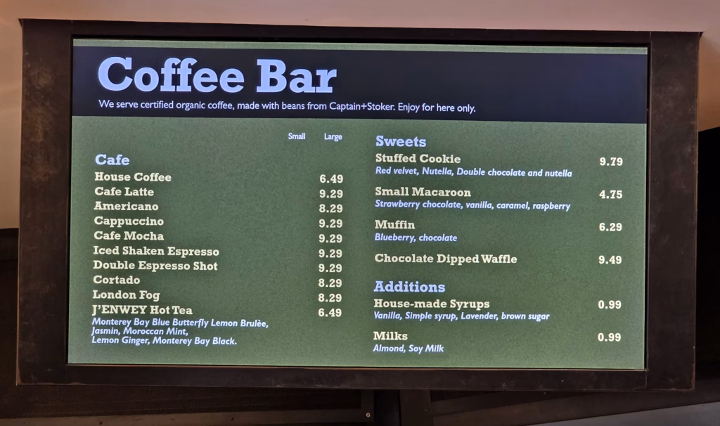 Coffee bar menu showing coffee drinks and treats at Monterey Bay Aquarium café counter