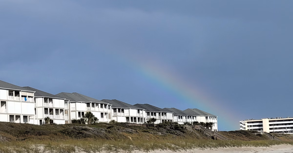 condo and hotel wide shot with sand and rainbow