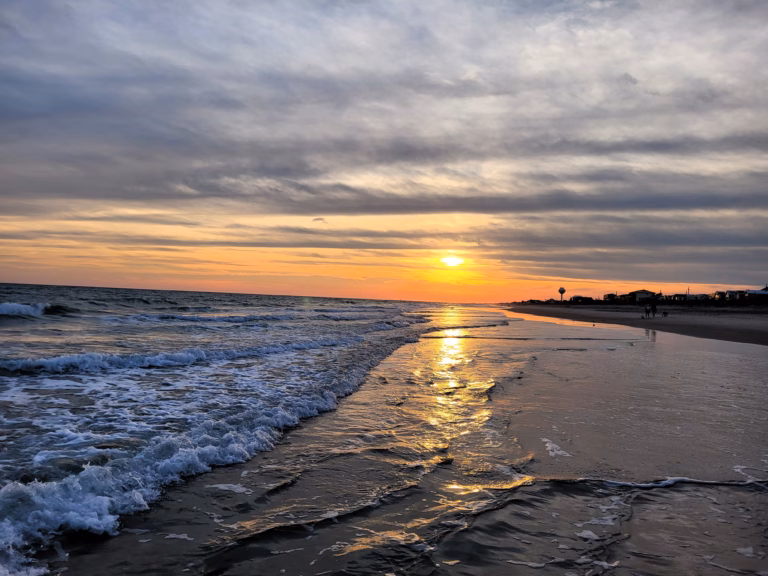 waves, sun, and water tower at Indian Beach near aquarium at pine knoll shores